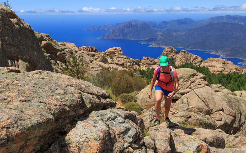 WomanhikingonatrailinthemountainsofCorsicaFrance